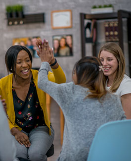 Two women giving each other a high-five