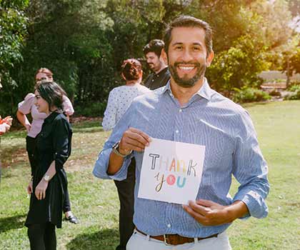 man holding thank you sign