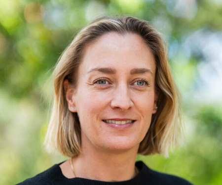Woman with short blond hair smiling
