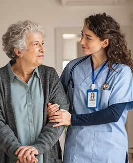 a nurse walking with an elderly woman