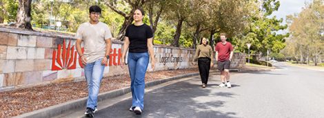 Students walking along a road at Logan