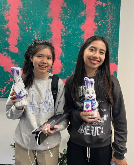 Two students posing with chocolate easter bunnies