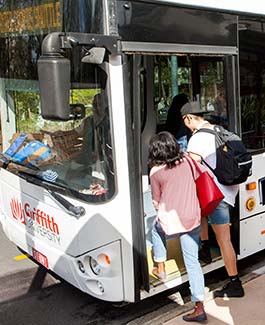 Students getting into the Intercampus shuttle bus at Nathan campus