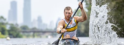 Male athlete paddling in a kayak