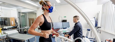 Female athlete running on a treadmill in a lab